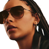 Model wearing Quay Unisex High Key Classic Aviator Sunglasses in Black Frame/Smoke to Coral Lens